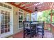 Inviting outdoor patio with pergola, ceiling fan, and dining table with seating at 10419 Chelsea Bay Dr, Charlotte, NC 28278