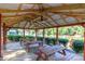 Interior view of a community pavilion with picnic tables and ceiling fans, set against a peaceful waterfront backdrop at 10419 Chelsea Bay Dr, Charlotte, NC 28278