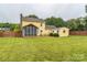 Spacious backyard view featuring a fenced yard and a screened-in porch at 105 Carmel Hills Dr, Gastonia, NC 28056