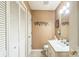 Well-lit half bathroom featuring a white vanity, toilet, and storage at 105 Carmel Hills Dr, Gastonia, NC 28056
