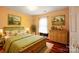 Cozy bedroom featuring wood floors, bright windows, and charming rustic accents at 105 Carmel Hills Dr, Gastonia, NC 28056