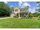 Charming two-story home with a well-manicured lawn and blue sky creating a welcoming curb appeal at 105 Carmel Hills Dr, Gastonia, NC 28056