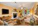 Inviting living room with a cozy fireplace, warm colors, hardwood floors, and comfortable wicker furniture at 105 Carmel Hills Dr, Gastonia, NC 28056