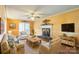 Cozy living room with a fireplace, a ceiling fan, hardwood floors, and comfortable wicker furniture at 105 Carmel Hills Dr, Gastonia, NC 28056