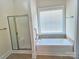 Bright bathroom showing a separate tub and shower with silver hardware, plus a large window at 1108 Tarram Ct # 12, Lancaster, SC 29720