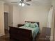 Cozy bedroom featuring a wood sleigh bed and dresser, plus neutral walls and curtains at 1108 Tarram Ct # 12, Lancaster, SC 29720
