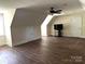 Large bonus room with light walls and dark floors, plus a tv against the wall at 1108 Tarram Ct # 12, Lancaster, SC 29720