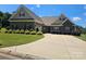 Beautiful home with stone and brick facade, an expansive driveway, and a manicured lawn with lovely bushes at 1108 Tarram Ct # 12, Lancaster, SC 29720