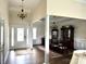 Elegant foyer with hardwood floors, chandelier, and view to the dining room with wainscoting and pillars at 1108 Tarram Ct # 12, Lancaster, SC 29720