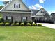 Charming two-story home with a well-manicured lawn and attractive landscaping, including shrubs and trees at 1108 Tarram Ct # 12, Lancaster, SC 29720