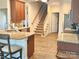Open-concept kitchen with granite countertops, stainless appliances, and a view of the staircase at 1108 Tarram Ct # 12, Lancaster, SC 29720