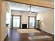 Open living room featuring hardwood floors, a fireplace, and large windows for natural light, with stylish decor at 1108 Tarram Ct # 12, Lancaster, SC 29720