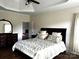 Bright main bedroom featuring tray ceilings, dark wood floors, and a lovely accent wall mirror at 1108 Tarram Ct # 12, Lancaster, SC 29720