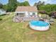 Aerial view of the property showcasing a pool, spacious deck, and fenced backyard on a sunny day at 115 Meadow Lake Dr, Salisbury, NC 28146
