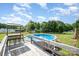 Backyard featuring an above ground pool with wooden deck and bar seating overlooking a green lawn and mature trees at 115 Meadow Lake Dr, Salisbury, NC 28146