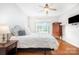Bright bedroom features wood floors, ceiling fan, and classic furnishings at 115 Meadow Lake Dr, Salisbury, NC 28146
