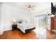 Bright bedroom with wood floors, ceiling fan, sliding glass door and ensuite bath at 115 Meadow Lake Dr, Salisbury, NC 28146