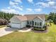 Charming single story home with well manicured lawn, attached garage, and driveway at 115 Meadow Lake Dr, Salisbury, NC 28146