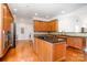 Kitchen boasts wood floors, cabinets and island with granite countertop, and stainless steel appliances at 115 Meadow Lake Dr, Salisbury, NC 28146