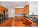 Bright kitchen features stainless appliances, wood cabinets, and granite countertops at 115 Meadow Lake Dr, Salisbury, NC 28146