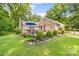 A view of the home's backyard featuring a patio with outdoor furniture and well-manicured landscaping at 120 Labans Ln, Lincolnton, NC 28092
