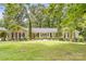 Charming brick home featuring a welcoming double door entry, well-manicured landscaping, and mature trees at 120 Labans Ln, Lincolnton, NC 28092