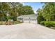Spacious two-car garage with additional parking, surrounded by lush greenery and mature trees at 120 Labans Ln, Lincolnton, NC 28092