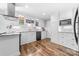 Bright kitchen featuring white cabinets, granite countertops, stainless steel appliances, and wood-look flooring at 120 Labans Ln, Lincolnton, NC 28092