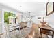 Open kitchen with white cabinets, stainless steel appliances, breakfast nook, and access to the outdoor living space at 120 Labans Ln, Lincolnton, NC 28092
