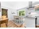 Bright kitchen featuring white cabinets, stainless steel appliances, breakfast nook, and access to the backyard at 120 Labans Ln, Lincolnton, NC 28092
