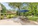 A patio overlooking a grassy backyard with shade trees and a view of the back of the house at 120 Labans Ln, Lincolnton, NC 28092