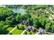 Panoramic aerial view of the upscale home with lake access, lush trees, and manicured lawns at 132 Parkside Ln, Mooresville, NC 28117