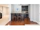 Bar area with dark wood cabinets, a granite countertop, and seating for two at 132 Parkside Ln, Mooresville, NC 28117