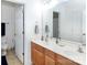 Bright bathroom featuring dual sinks, a large mirror, and a door to a separate toilet area at 132 Parkside Ln, Mooresville, NC 28117