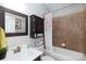 Cozy bathroom featuring a tub/shower combo, vanity, and a decorative mirror, basket, and wall art at 132 Parkside Ln, Mooresville, NC 28117