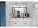 Bathroom with a double vanity, wooden mirror frame, and a shower/tub combination at 132 Parkside Ln, Mooresville, NC 28117