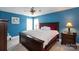 Cozy bedroom featuring a king-sized bed, blue walls, and natural light from two windows at 132 Parkside Ln, Mooresville, NC 28117