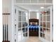 Inviting bedroom features French doors, a tufted headboard and natural light at 132 Parkside Ln, Mooresville, NC 28117