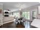 Cozy dining area merges with a spacious living room with fireplace and many windows at 132 Parkside Ln, Mooresville, NC 28117