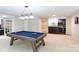 Basement game room with a billiards table, bar area, and ample space for entertaining at 132 Parkside Ln, Mooresville, NC 28117