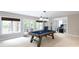 Spacious game room features a pool table, natural light, and access to the outside at 132 Parkside Ln, Mooresville, NC 28117