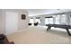 Spacious game room with a pool table, sitting area, and plenty of natural light from the windows at 132 Parkside Ln, Mooresville, NC 28117