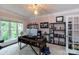 Bright home office with large windows, a modern desk, and ample shelving for storage and decor at 132 Parkside Ln, Mooresville, NC 28117