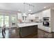 Open kitchen featuring a large island, modern appliances, and a seamless connection to the outdoors at 132 Parkside Ln, Mooresville, NC 28117
