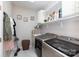 Functional laundry room with modern appliances, overhead shelving, and stylish decor at 132 Parkside Ln, Mooresville, NC 28117