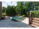 Backyard pool with waterfall feature, lush landscaping, and lounge chairs at 132 Parkside Ln, Mooresville, NC 28117