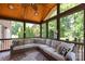 Relaxing sunroom featuring a wood ceiling, comfortable wicker furniture, and views of mature trees at 132 Parkside Ln, Mooresville, NC 28117