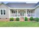 Inviting back porch with ceiling fans, outdoor seating, and access to a lush green yard at 1327 Springlake Rd, York, SC 29745