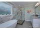 Bright bathroom featuring a soaking tub, glass-enclosed shower with pebble floor, and vanity with granite countertop at 1327 Springlake Rd, York, SC 29745