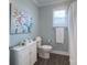 Well-lit bathroom featuring a toilet, vanity, cabinet, towel bar, and a shower with a curtain at 1327 Springlake Rd, York, SC 29745